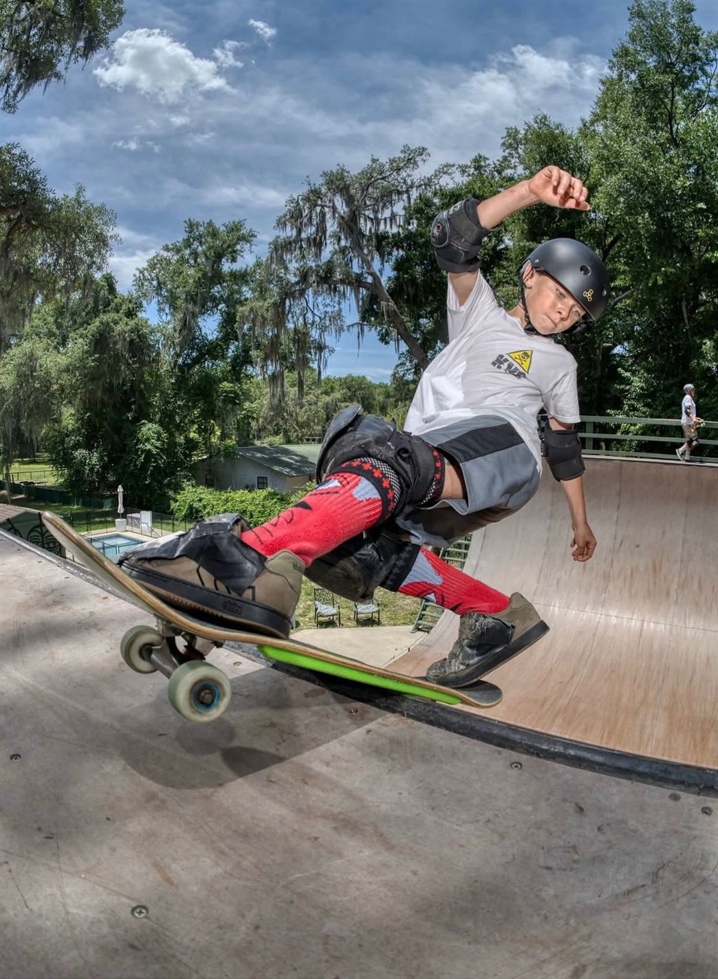 Skater carving the lip of the wooden vert ramp
